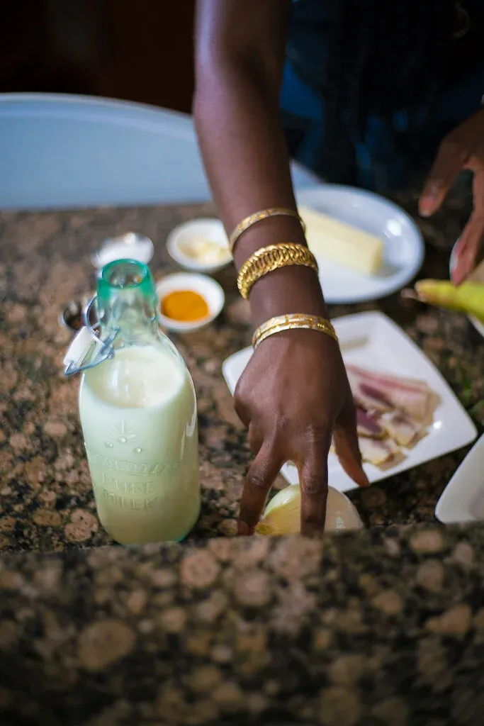 Hands preparing ingredients on a granite countertop during a shoot